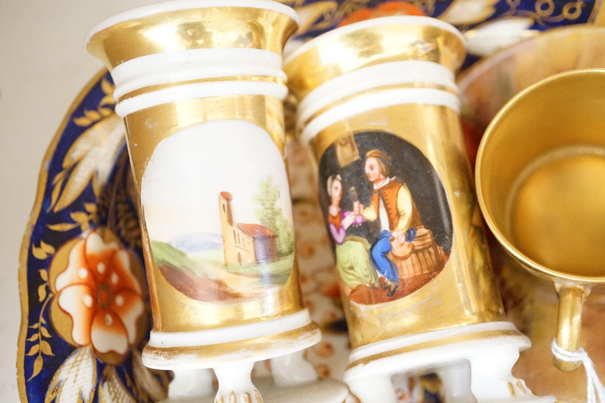 A pair of bisque swinging figures, Royal Worcester cabinet cup and saucer and five other items